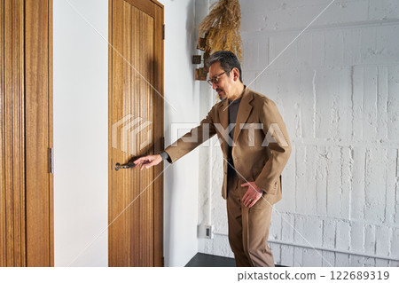 A man who feels the need to urinate and enters the toilet 122689319