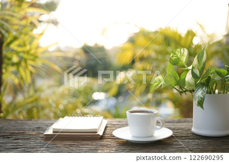 White coffee cup and notebook Cozy outdoor writing 122690295