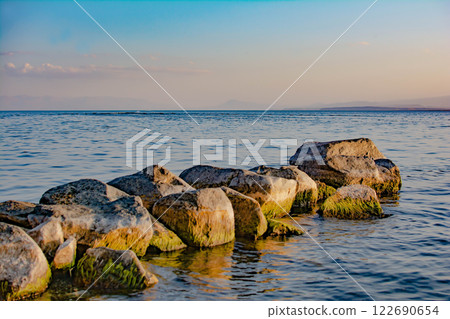 Sandy beach. Seaside vacation, golden beaches. Blue waters of the sea. Lake, ocean, sea 122690654