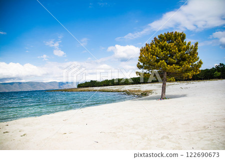 Sandy beach. Seaside vacation, golden beaches. Blue waters of the sea. Lake, ocean, sea Sandy beach. Seaside vacation, golden beaches. Blue waters of the sea. Lake, ocean, sea 122690673
