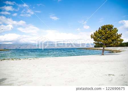Sandy beach. Seaside vacation, golden beaches. Blue waters of the sea. Lake, ocean, sea Sandy beach. Seaside vacation, golden beaches. Blue waters of the sea. Lake, ocean, sea 122690675