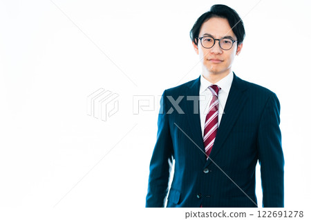 A businessman in his 30s wearing a suit and glasses on a white background A businessman in his 30s wearing a suit and glasses on a white background 122691278