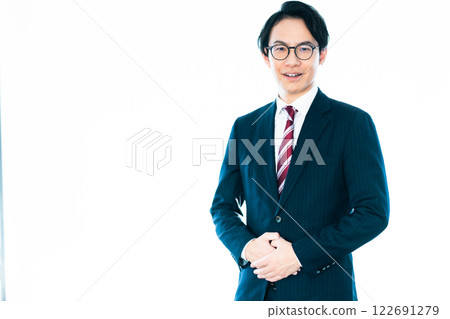 A businessman in his 30s wearing a suit and glasses on a white background A businessman in his 30s wearing a suit and glasses on a white background 122691279