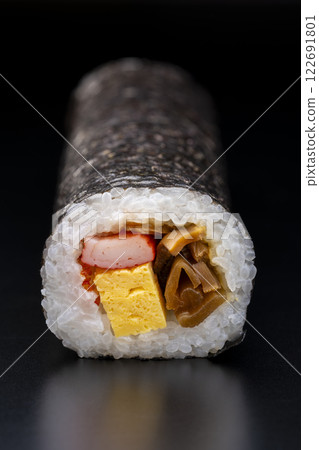 Close-up of a cross section of a lucky charm, Ehomaki, on a black background 122691801
