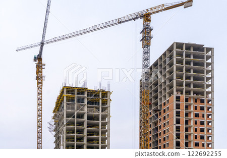 Construction of modern apartments. Construction site with cranes background 122692255