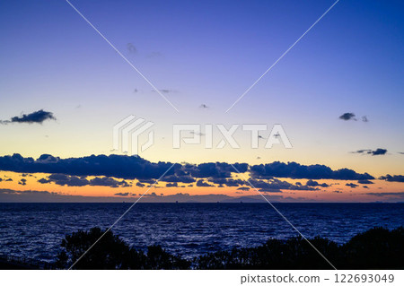Sunset at Akashi Strait in Hyogo Prefecture. The sun sets with Awaji Island in the background. Sunset at Akashi Strait in Hyogo Prefecture. The sun sets with Awaji Island in the background. 122693049