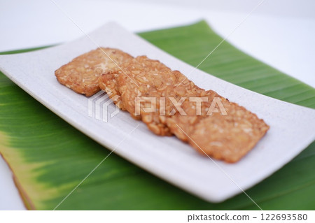 Fried tempeh is a popular Indonesian dish made from tempeh 122693580