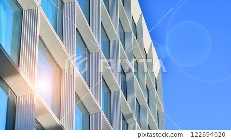 Large glass windows in a modern hotel building. Modern urban architecture. Large expanses of glass in concrete wall panels. Large glass windows in a modern hotel building. Modern urban architecture. Large expanses of glass in concrete wall panels. 122694020