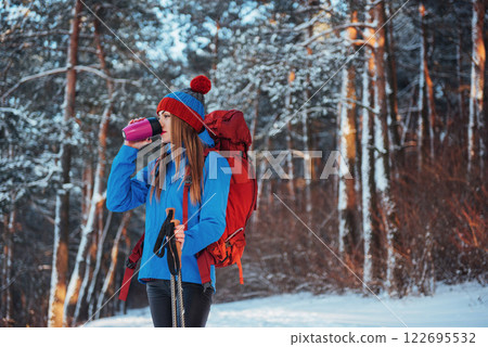 Woman Traveler with backpack hiking Travel Lifestyle adventure concept active vacations outdoor. Beautiful landscape forest 122695532
