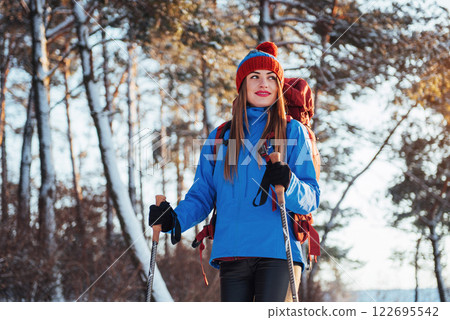 Woman Traveler with backpack hiking Travel Lifestyle adventure concept active vacations outdoor. Beautiful landscape forest Woman Traveler with backpack hiking Travel Lifestyle adventure concept active vacations outdoor. Beautiful landscape forest 122695542