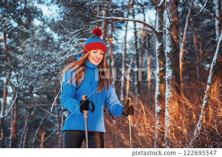 Woman Traveler with backpack hiking Travel Lifestyle adventure concept active vacations outdoor. Beautiful landscape forest Woman Traveler with backpack hiking Travel Lifestyle adventure concept active vacations outdoor. Beautiful landscape forest 122695547