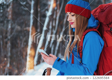 Woman Traveler with backpack hiking Travel Lifestyle adventure concept active vacations outdoor. Beautiful landscape forest Woman Traveler with backpack hiking Travel Lifestyle adventure concept active vacations outdoor. Beautiful landscape forest 122695564