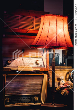 obsolete radio players and old vintage lamp. retro electronics with wooden case 122695643