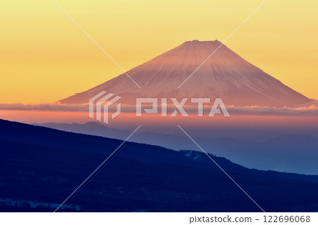 Mount Fuji dyed red by the morning glow floating in a sea of clouds Mount Fuji dyed red by the morning glow floating in a sea of clouds 122696068