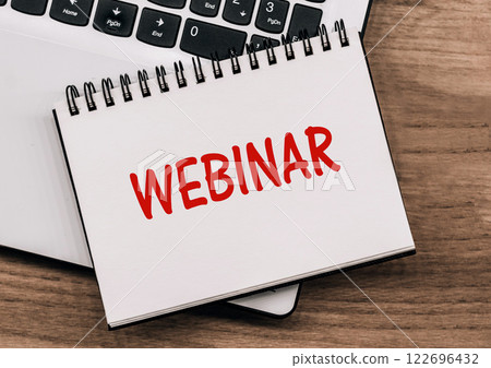 Webinar Text on note pad with computer keyboard 122696432
