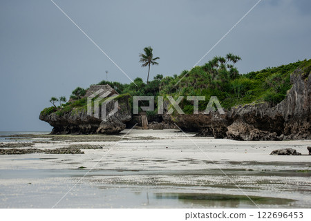 Landscape of the Indian Ocean coastline with at Mtende Beach, Zanzibar. Rocks and white sand. View from the sea 122696453