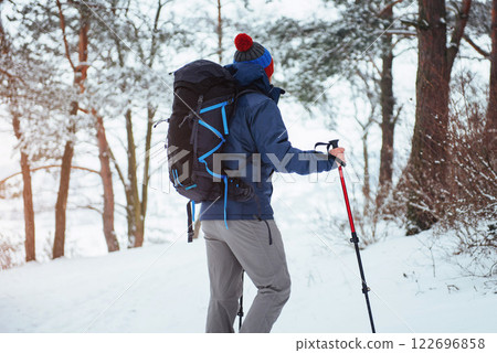Man Traveler with backpack hiking Travel Lifestyle adventure concept active vacations outdoor. Beautiful landscape forest 122696858