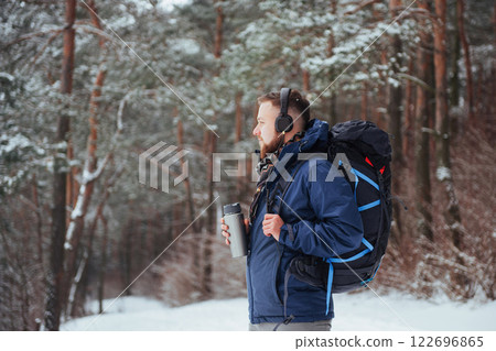 Man Traveler with backpack hiking Travel Lifestyle adventure concept active vacations outdoor. Beautiful landscape forest 122696865