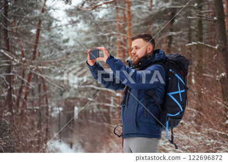 Man Traveler with backpack hiking Travel Lifestyle adventure concept active vacations outdoor. Beautiful landscape forest Man Traveler with backpack hiking Travel Lifestyle adventure concept active vacations outdoor. Beautiful landscape forest 122696872