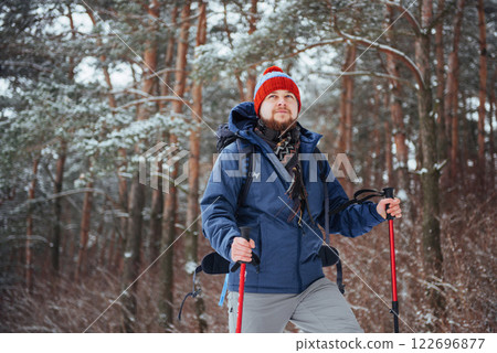 Man Traveler with backpack hiking Travel Lifestyle adventure concept active vacations outdoor. Beautiful landscape forest 122696877