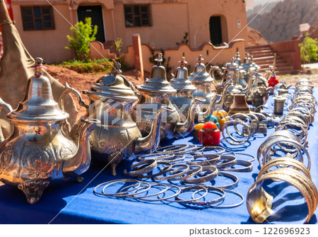 Multicolored Moroccan craft souvenirs at the market. Teapots and plates , decorations, tagines,, trinkets Multicolored Moroccan craft souvenirs at the market. Teapots and plates , decorations, tagines,, trinkets 122696923