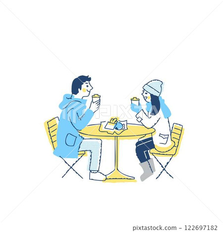 Couple in winter clothes relaxing at an open cafe 122697182