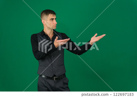 Photo of amazing guy indicating fingers up to empty space advising cool low shopping prices wear casual denim shirt isolated green color background 122697183