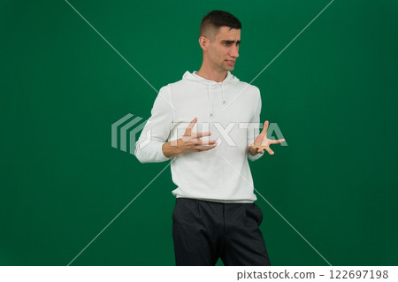 Photo of amazing guy indicating fingers up to empty space advising cool low shopping prices wear casual denim shirt isolated green color background Photo of amazing guy indicating fingers up to empty space advising cool low shopping prices wear casual denim shirt isolated green color background 122697198