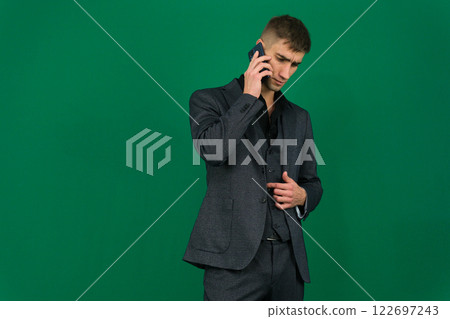 businessman holding a laptop computer while on the phone isolated white background businessman holding a laptop computer while on the phone isolated white background 122697243