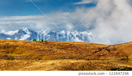 Autumn landscape and snow mountains in beautiful cumulus clouds. Main Caucasian Ridge. Type Mount Ushba Mheyer, Georgia Autumn landscape and snow mountains in beautiful cumulus clouds. Main Caucasian Ridge. Type Mount Ushba Mheyer, Georgia 122697296