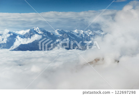 Autumn landscape and snow mountains in beautiful cumulus clouds. Main Caucasian Ridge. Type Mount Ushba Mheyer, Georgia Autumn landscape and snow mountains in beautiful cumulus clouds. Main Caucasian Ridge. Type Mount Ushba Mheyer, Georgia 122697298
