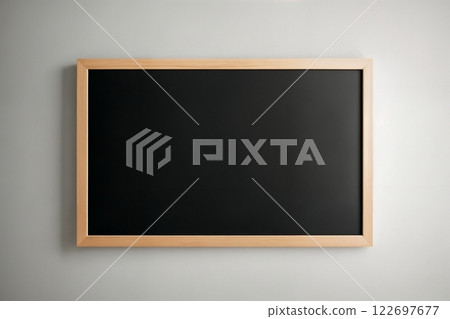 empty black chalkboard against gray wall 122697677