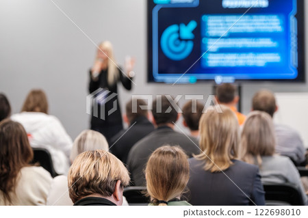 Group of people attending a business presentation in a conference room 122698010