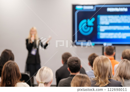 Professional presentation in a conference room with attentive audience members 122698011