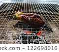 Eggplant being grilled on a charcoal grill 122698016