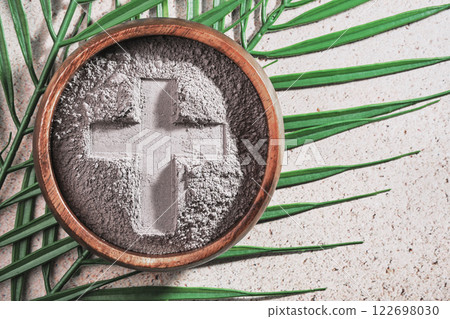 Ash Wednesday. Cross in ashes on a palm leaf background Ash Wednesday. Cross in ashes on a palm leaf background 122698030
