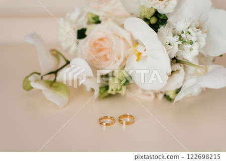 Close up Of Wedding Rings And White Flowers 122698215
