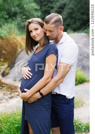 Romantic Moment Of Loving Pregnant Couple In Nature Romantic Moment Of Loving Pregnant Couple In Nature 122698228