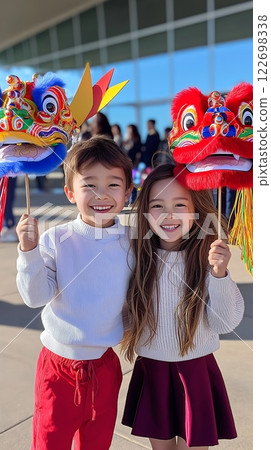 Asian children celebrating with colorful dragon heads at cultural festival 122698338