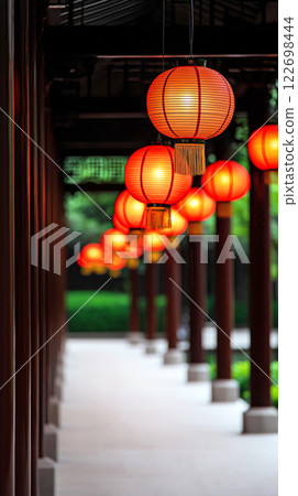 Traditional red lanterns adorning asian temple corridor at dusk Traditional red lanterns adorning asian temple corridor at dusk 122698444