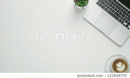 Stylish workspace with laptop, coffee, and plant on minimalist desk 122698705