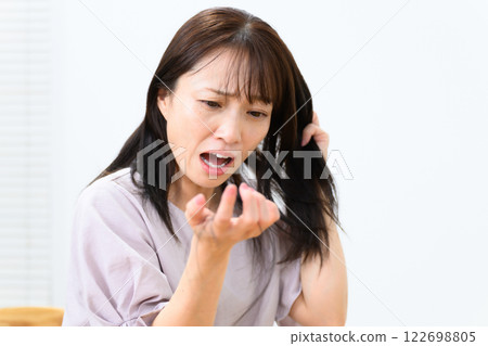 Female hair loss alopecia FAGA 122698805