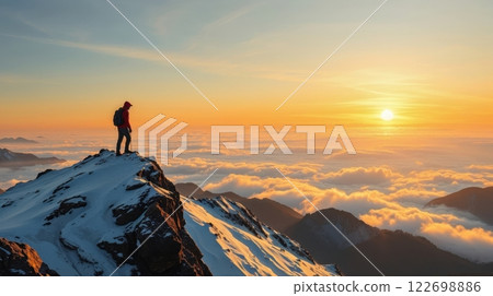 A lone hiker on snowy mountain at sunset A lone hiker on snowy mountain at sunset 122698886