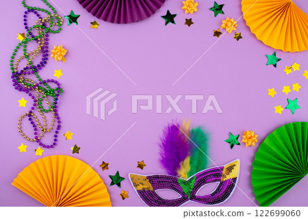 Vibrant Mardi Gras background with mask, beads, and festive decorations 122699060