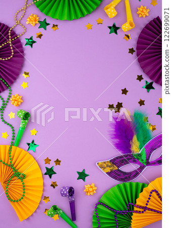 Vibrant Mardi Gras background with mask, beads, and festive decorations Vibrant Mardi Gras background with mask, beads, and festive decorations 122699071