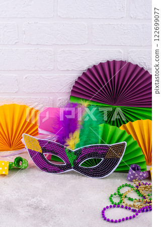 Vibrant Mardi Gras background with mask, beads, and festive decorations 122699077