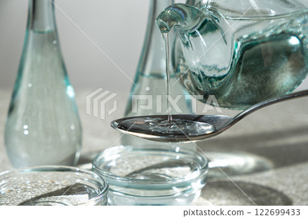 White distilled vinegar is poured into spoon White distilled vinegar is poured into spoon 122699433