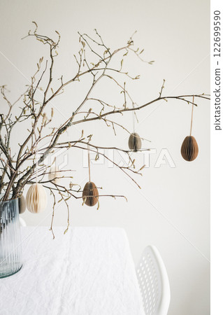 Easter paper eggs hanging on branches. Easter tablescape decor. Easter paper eggs hanging on branches. Easter tablescape decor. 122699590