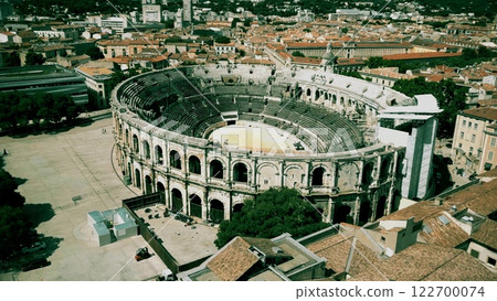 Looping FPV drone aerial shot of the Arena of Nimes, a Roman amphitheater in Nimes, southern France Looping FPV drone aerial shot of the Arena of Nimes, a Roman amphitheater in Nimes, southern France 122700074