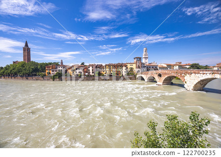 The Ponte Pietra roman arch bridge crossing the Adige River in Verona town, Italy, Europe. The Ponte Pietra roman arch bridge crossing the Adige River in Verona town, Italy, Europe. 122700235